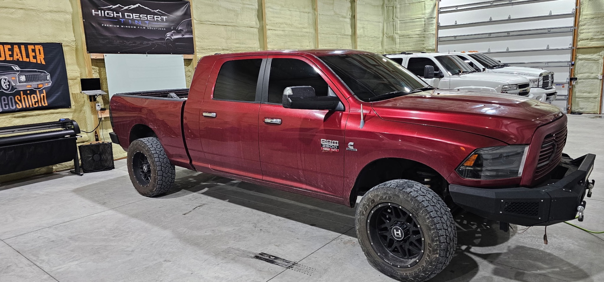 Dark red Ram 2500 Heavy Duty with premium window tint parked in the High Desert Tint bay