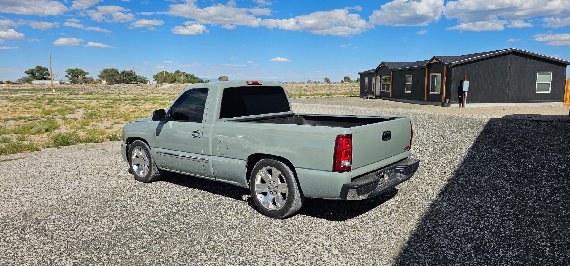 Sage green GMC Sierra single cab with tinted rear window