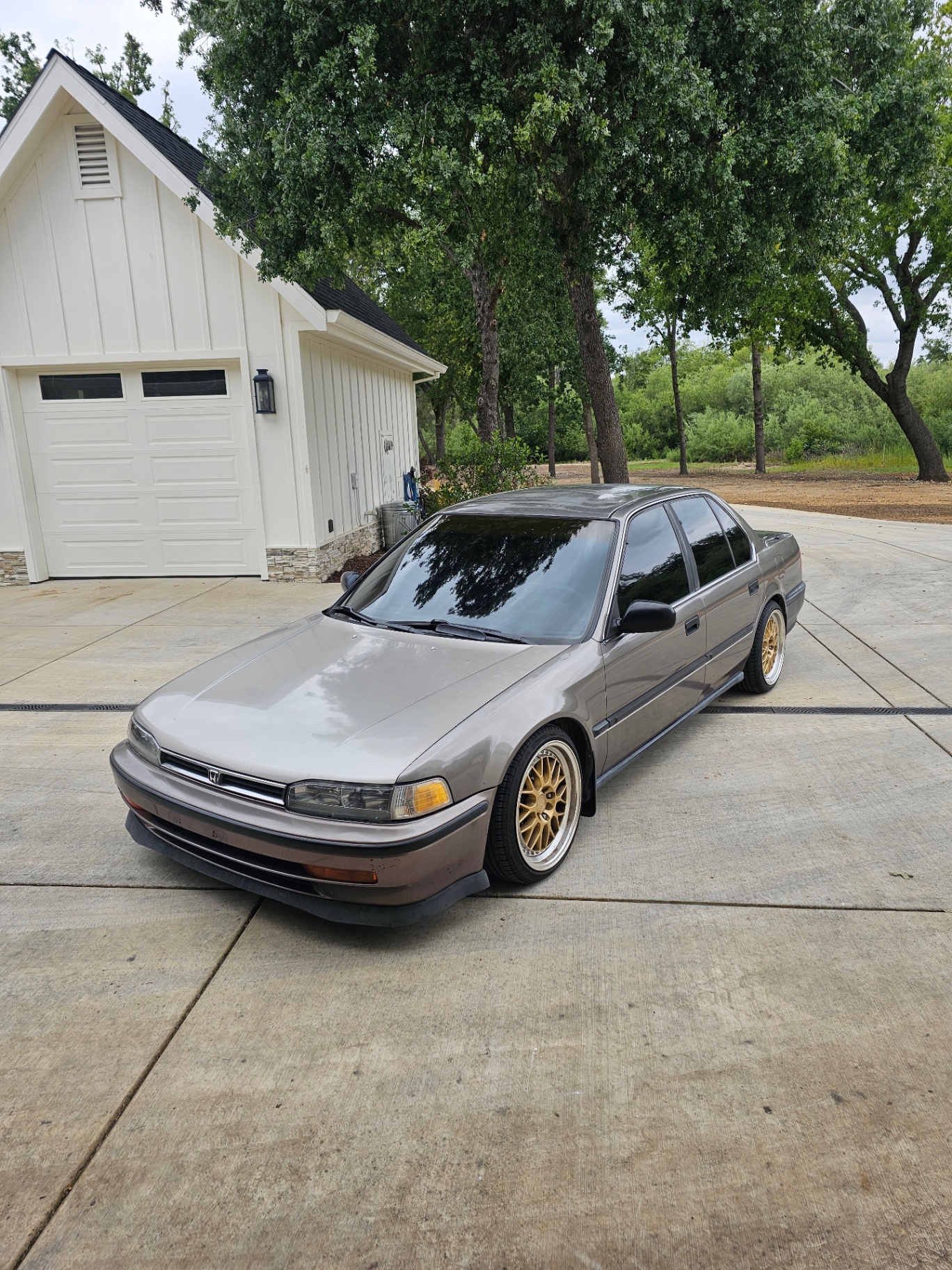 Tinted 1990s Honda Accord on gold wheels