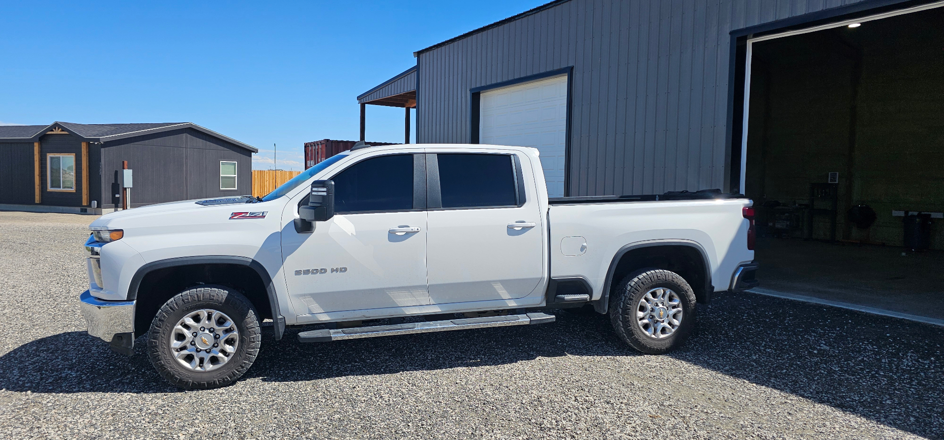 White Chevy Silverado 2500HD with fresh window tint outside the Fallon shop