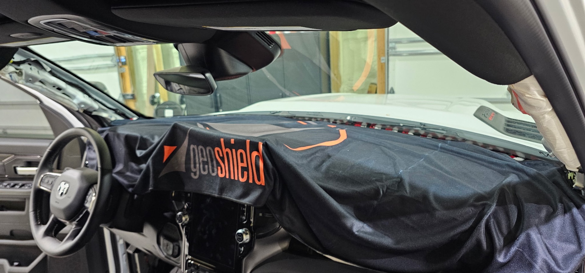 Ram truck windshield being tinted with Geoshield film in the Fallon shop