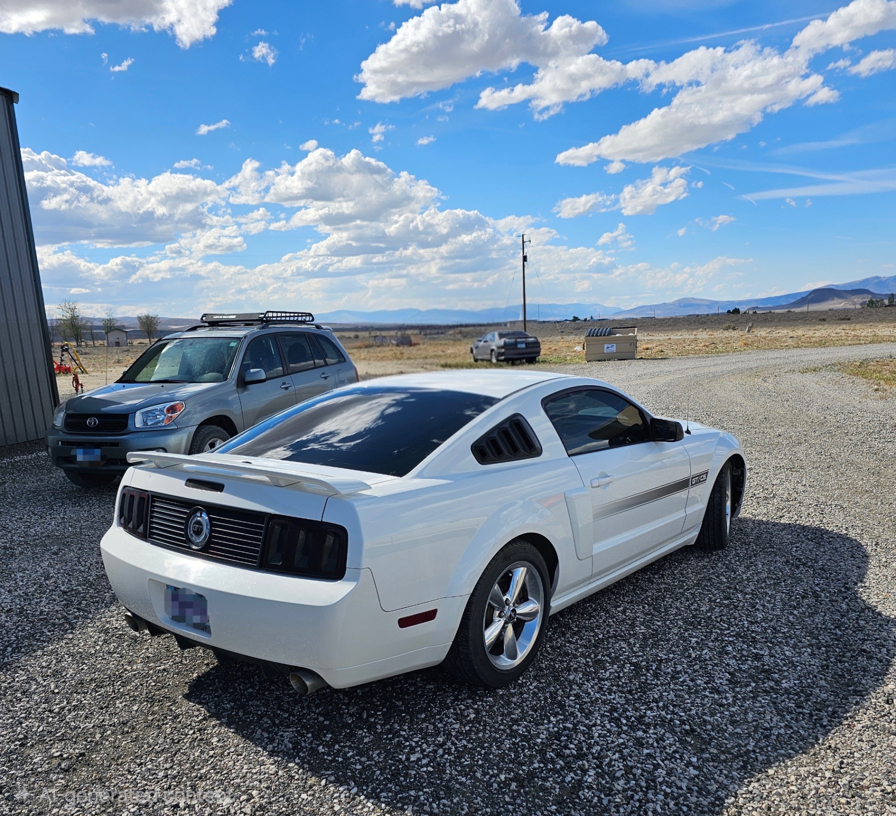 Rear view of tinted white Mustang GT/CS in the high desert