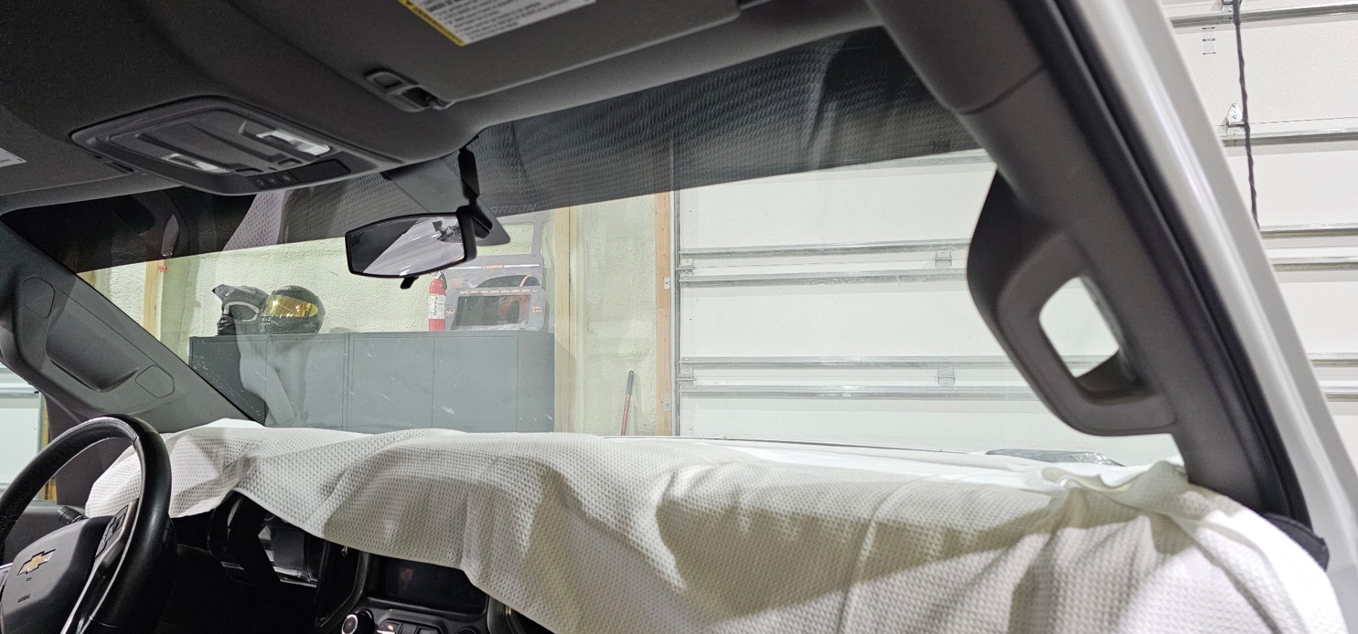 Ceramic windshield film being installed on a Chevy in the Fallon shop
