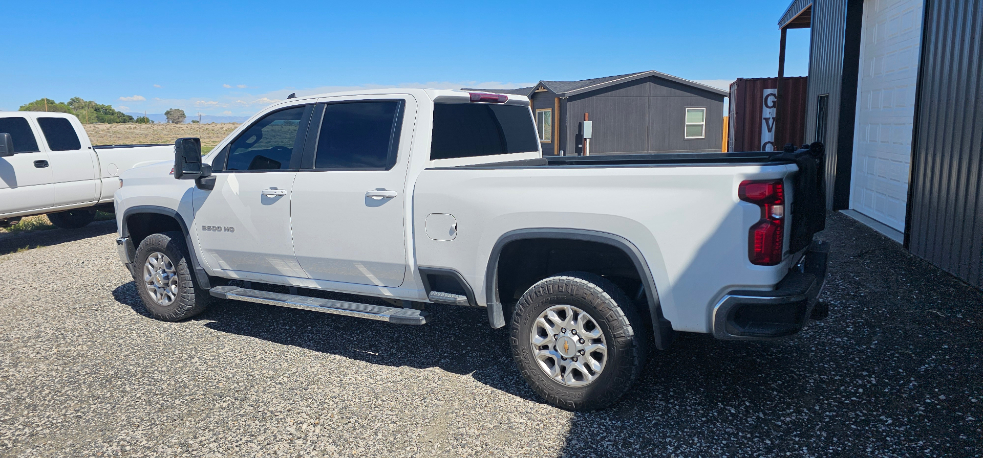 White Chevy Silverado 3500HD with fresh dark window tint outside the shop